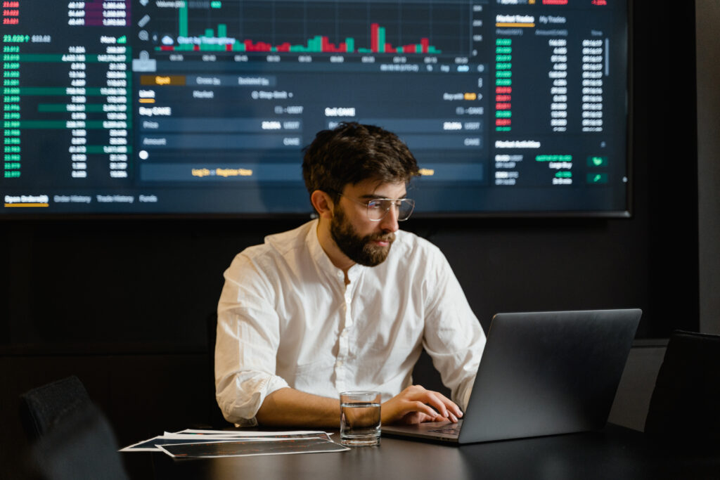 Man in white dress shirt using laptop