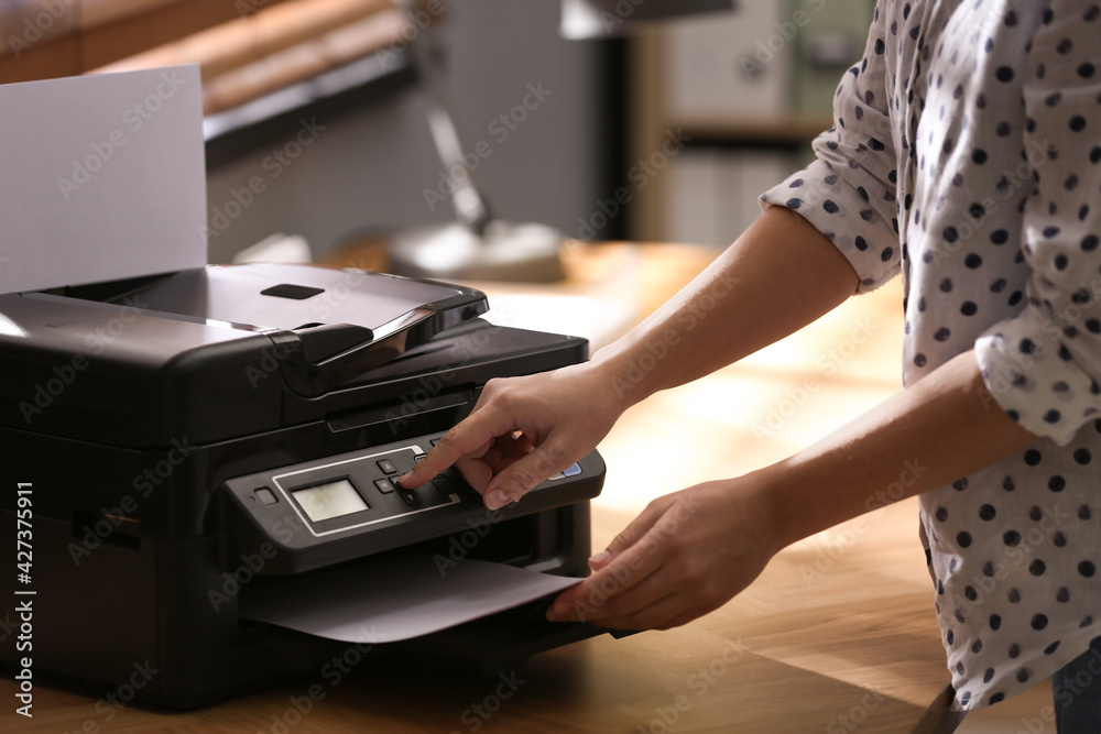 Employee using modern printer in office, closeup