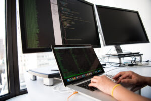 Close up photo of person typing on laptop